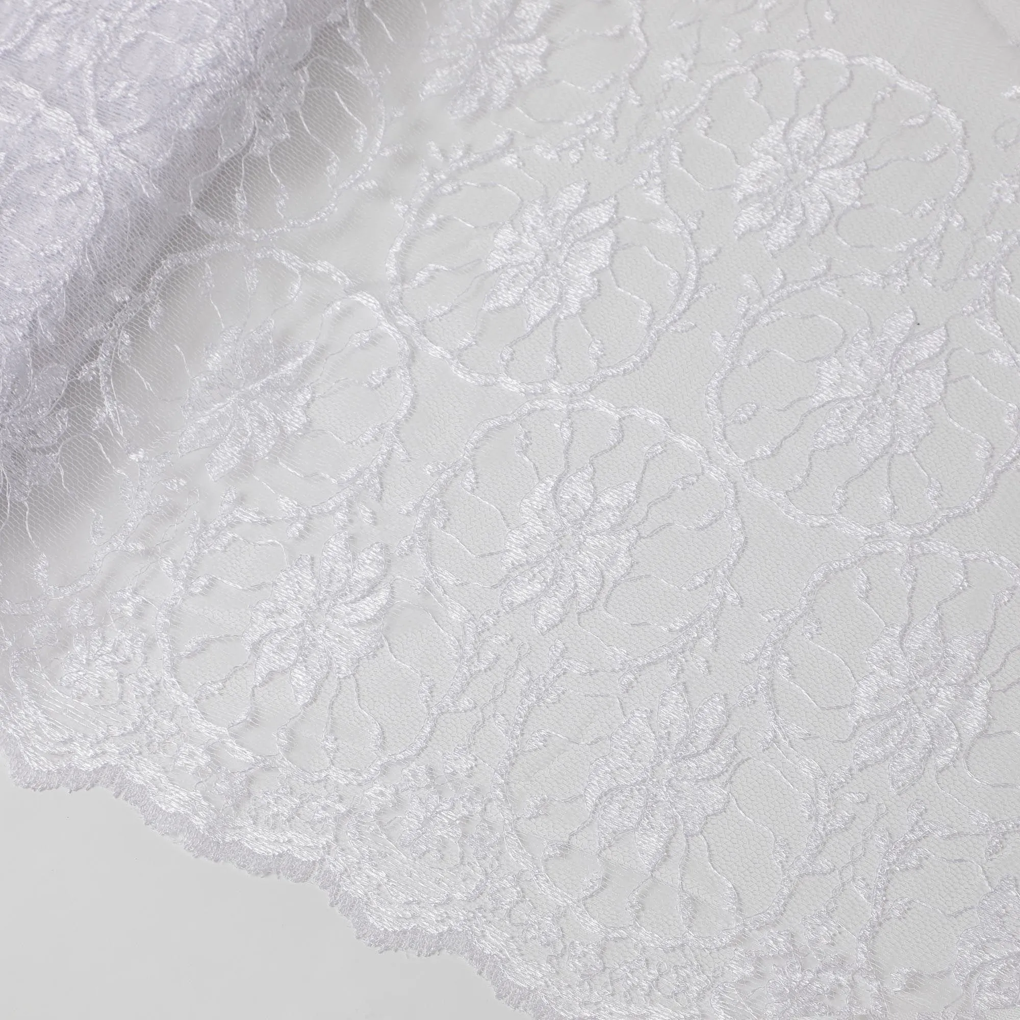 White lace fabric with embroidery in floral design